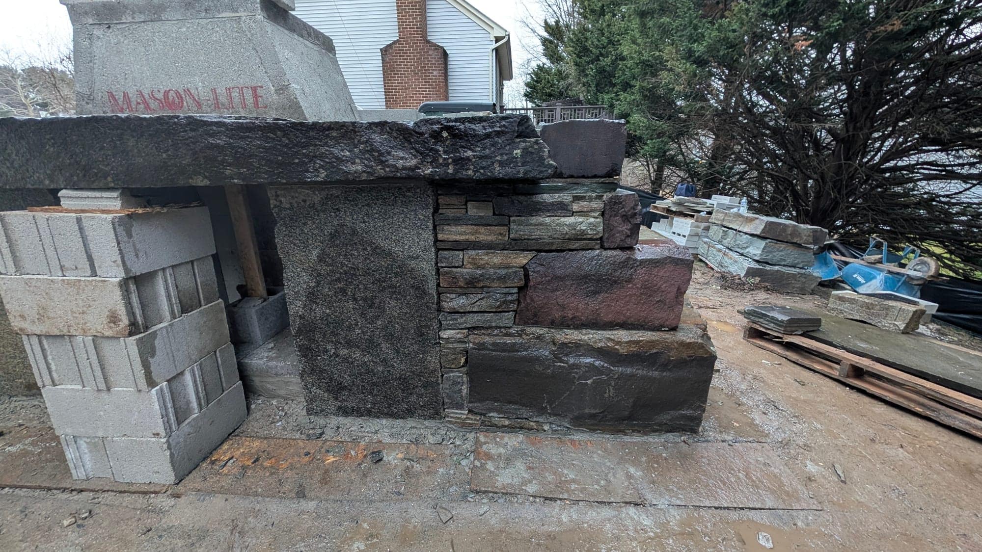Project Wildfire construction field photo 21, documenting the outdoor fireplace, patio, lounge, and upper deck build