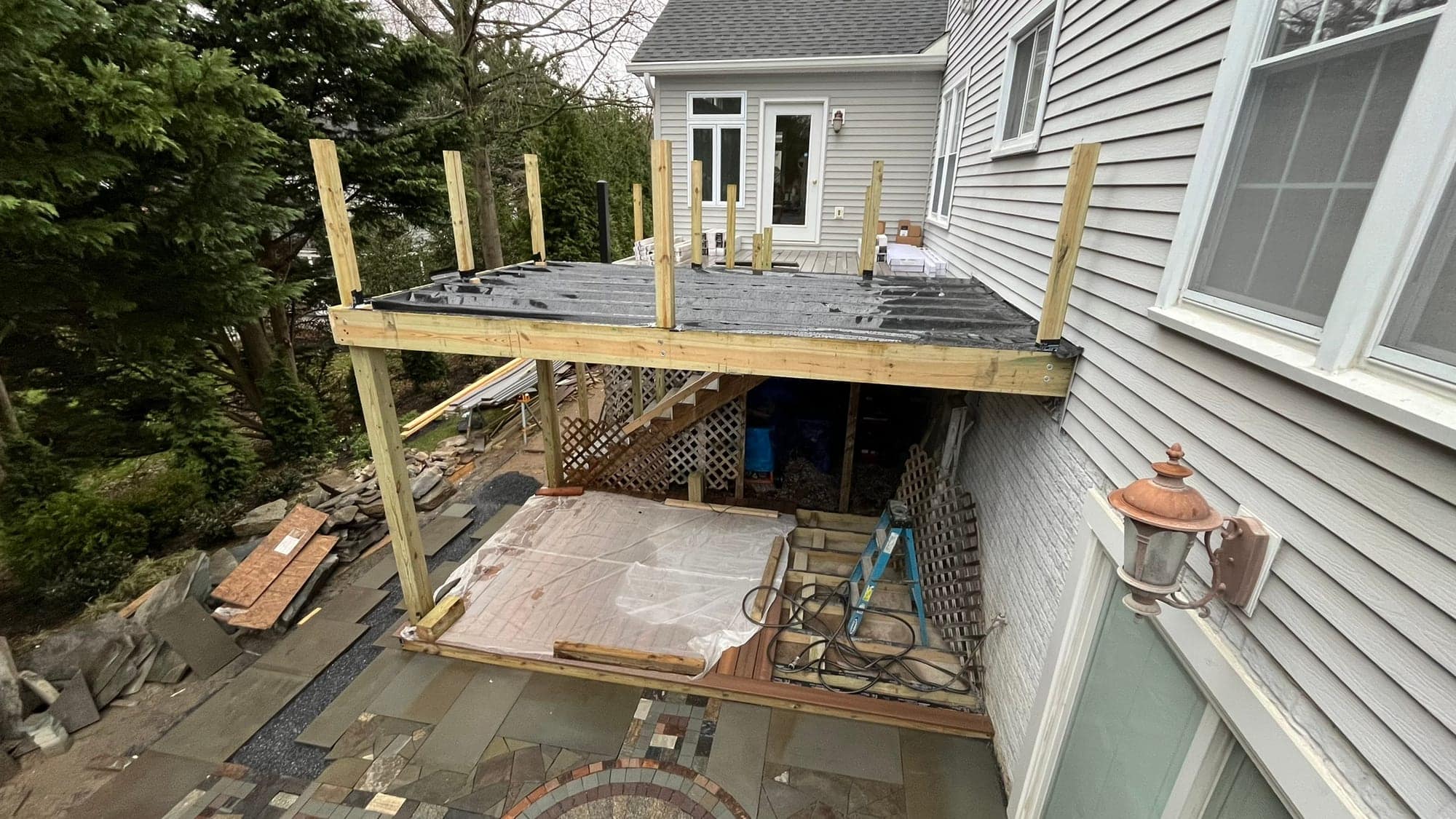 Project Wildfire construction field photo 61, documenting the outdoor fireplace, patio, lounge, and upper deck build
