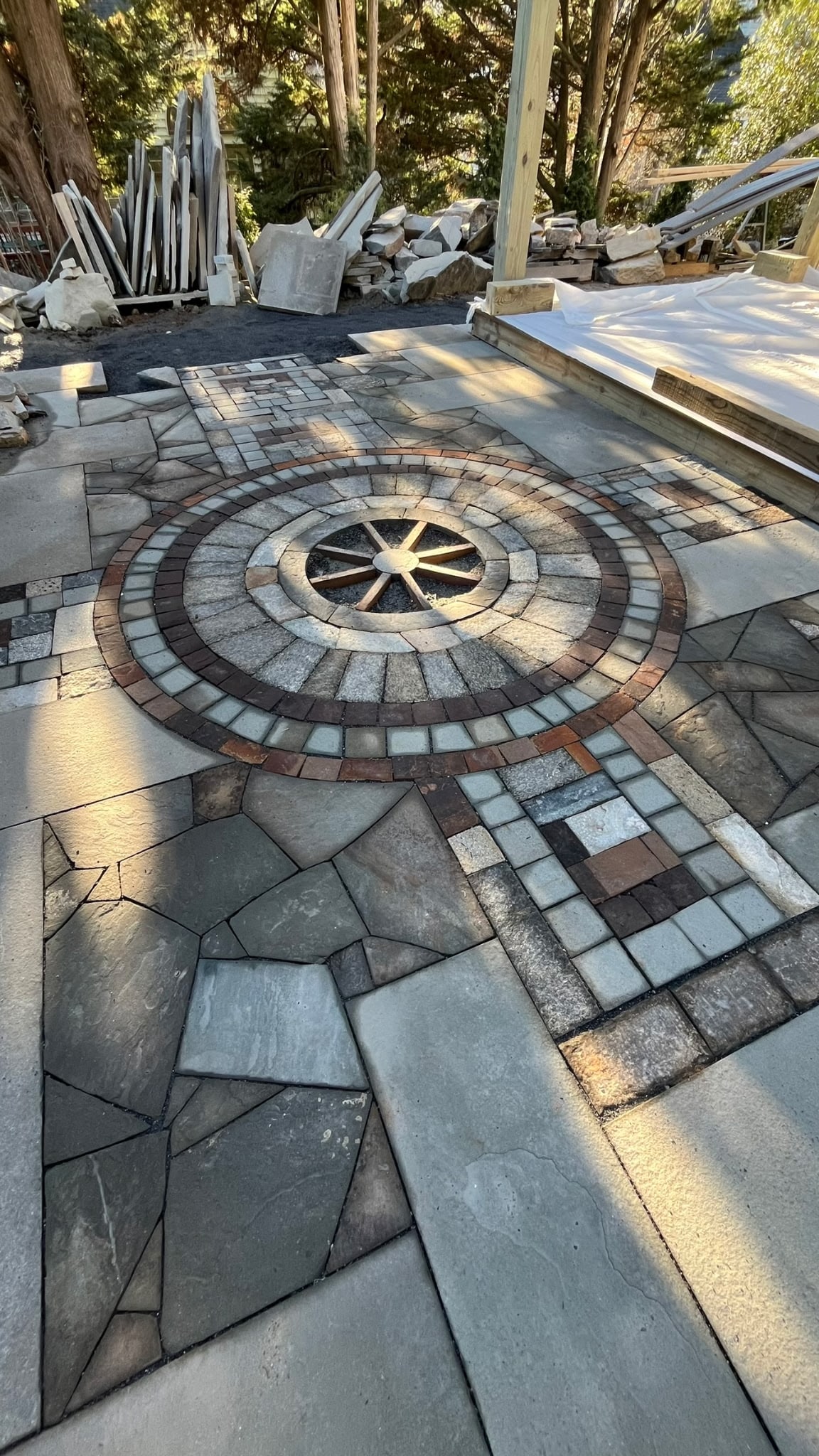 WildWorks stone compass rose medallion set into a mixed stone patio